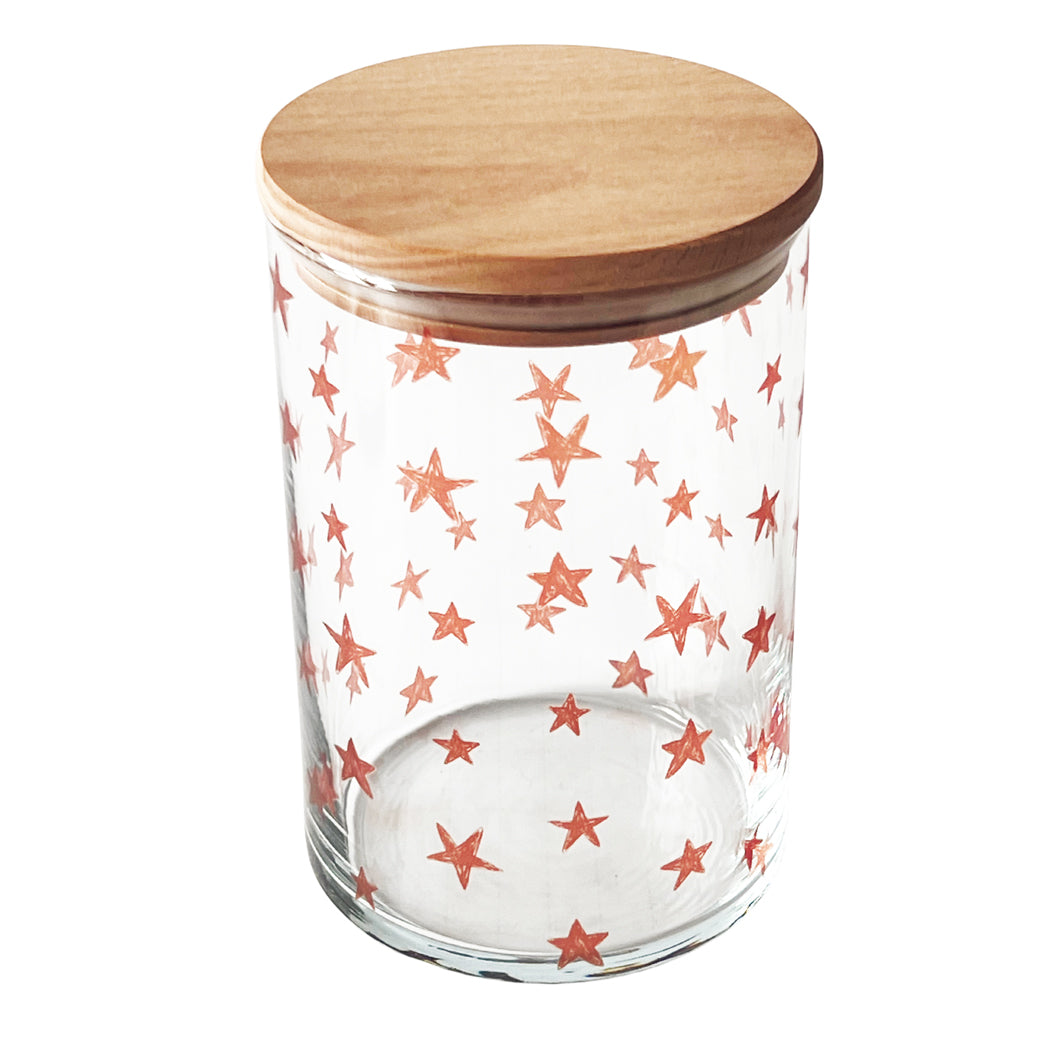 Transparentes Bonbonglas mit roten Sternen